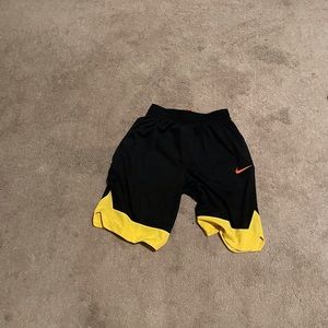 Black Nike shorts with Yellow on the bottoms